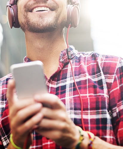 Man Listening to Music While Wearing Headphones